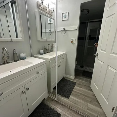 a bathroom with a double vanity sink and mirror