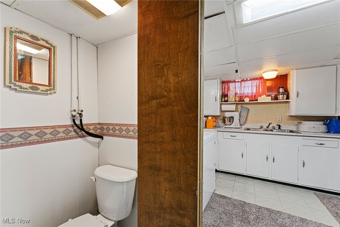 35221 Chestnut Ridge Road North Ridgeville, OH 44039 - Photo 42 of 48 Bathroom featuring a drop ceiling, vanity, washer / clothes dryer, and light tile patterned floors