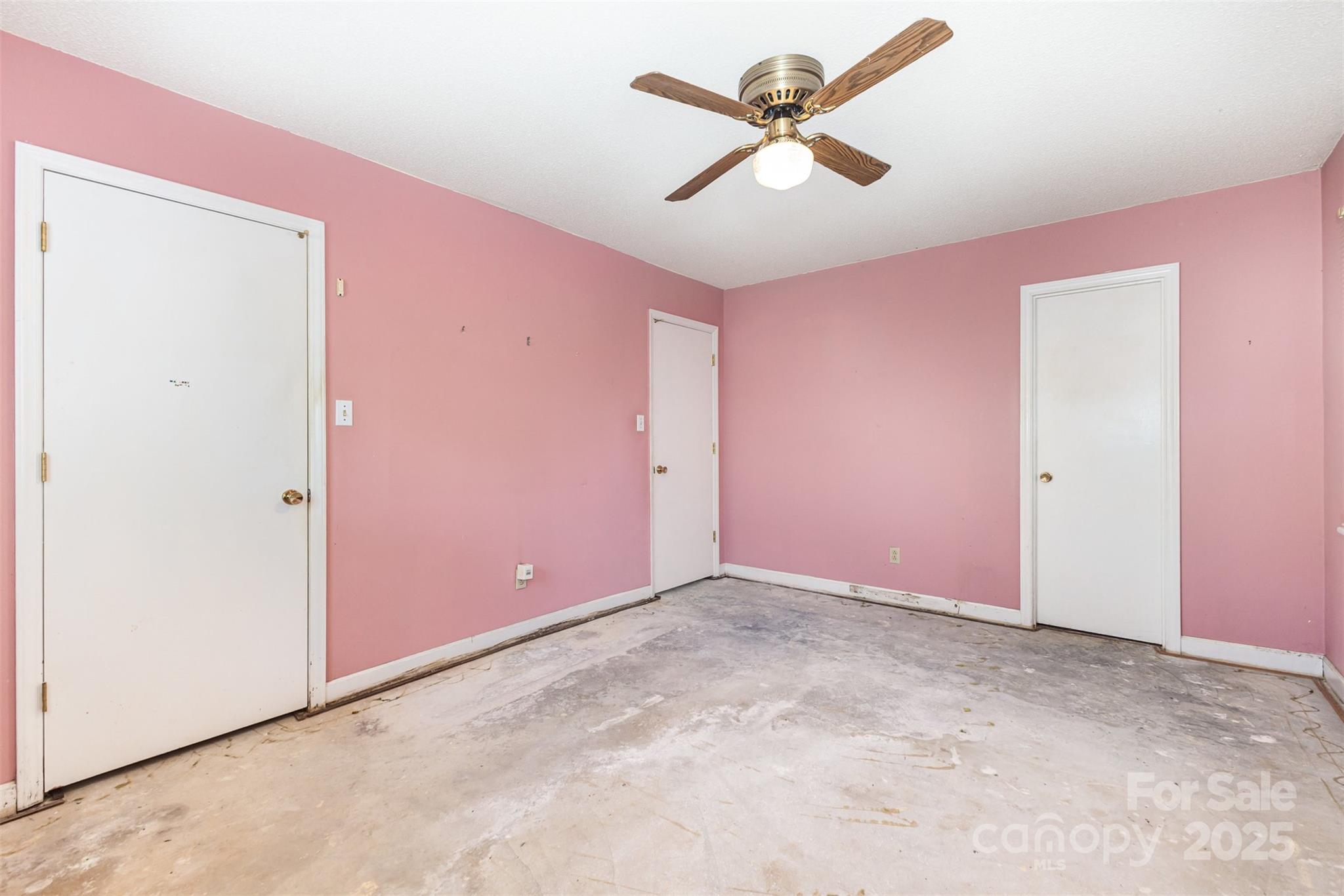 7428 Bradgate Road Charlotte, NC 28217 - Photo 16 of 27 an empty room with a ceiling fan and a window