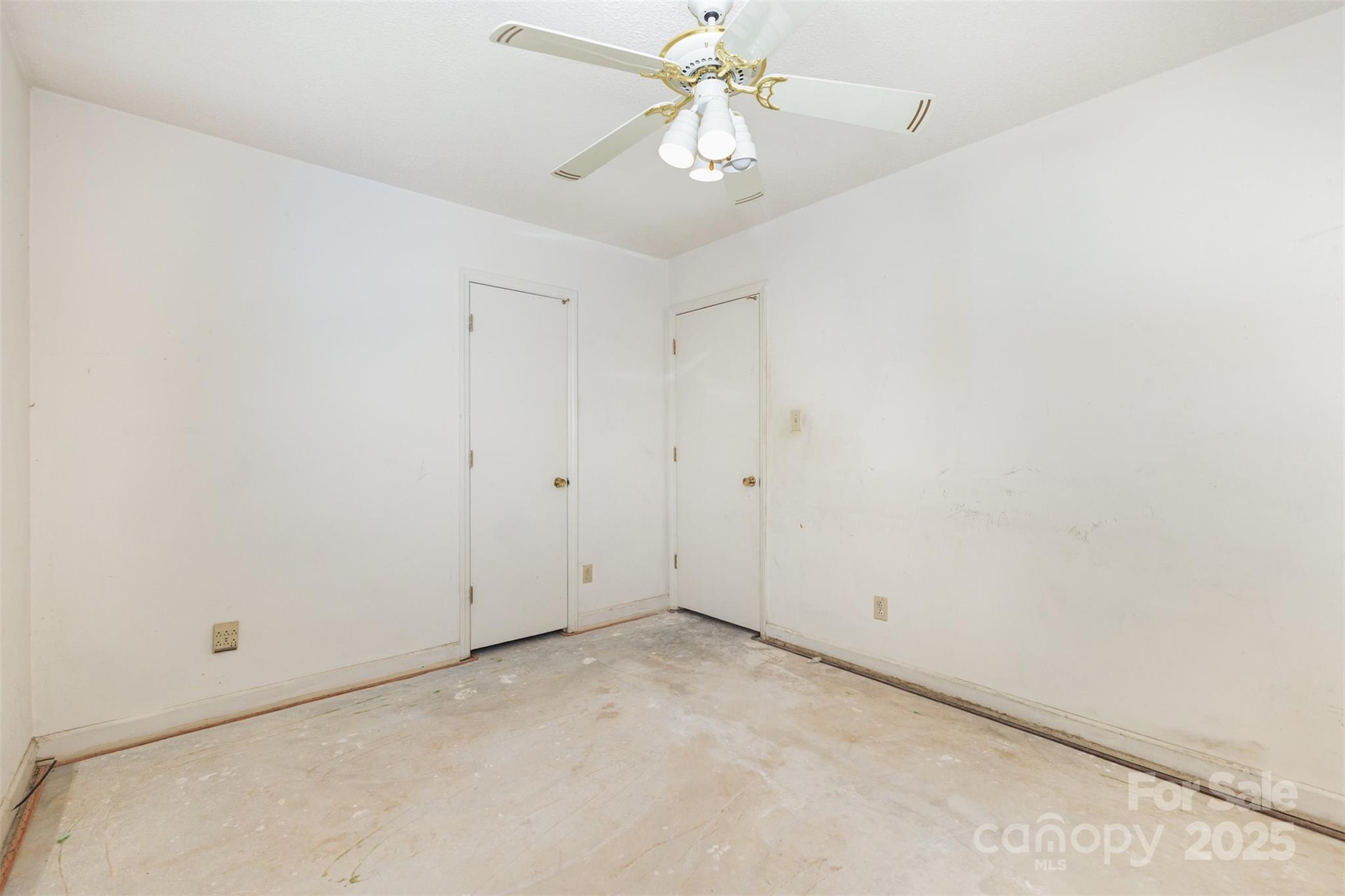 7428 Bradgate Road Charlotte, NC 28217 - Photo 18 of 27 an empty room with a chandelier fan and closet area