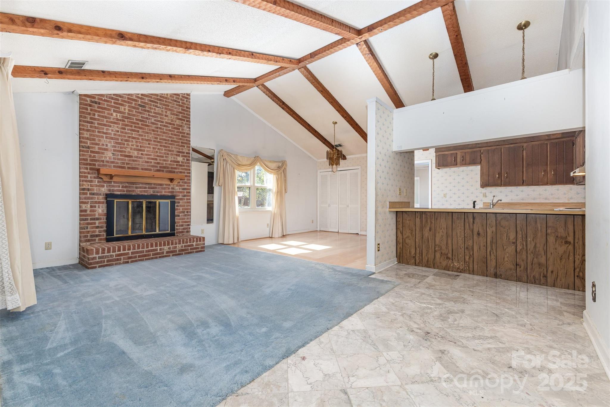 7428 Bradgate Road Charlotte, NC 28217 - Photo 2 of 27 a view of an empty room with a fireplace and a window