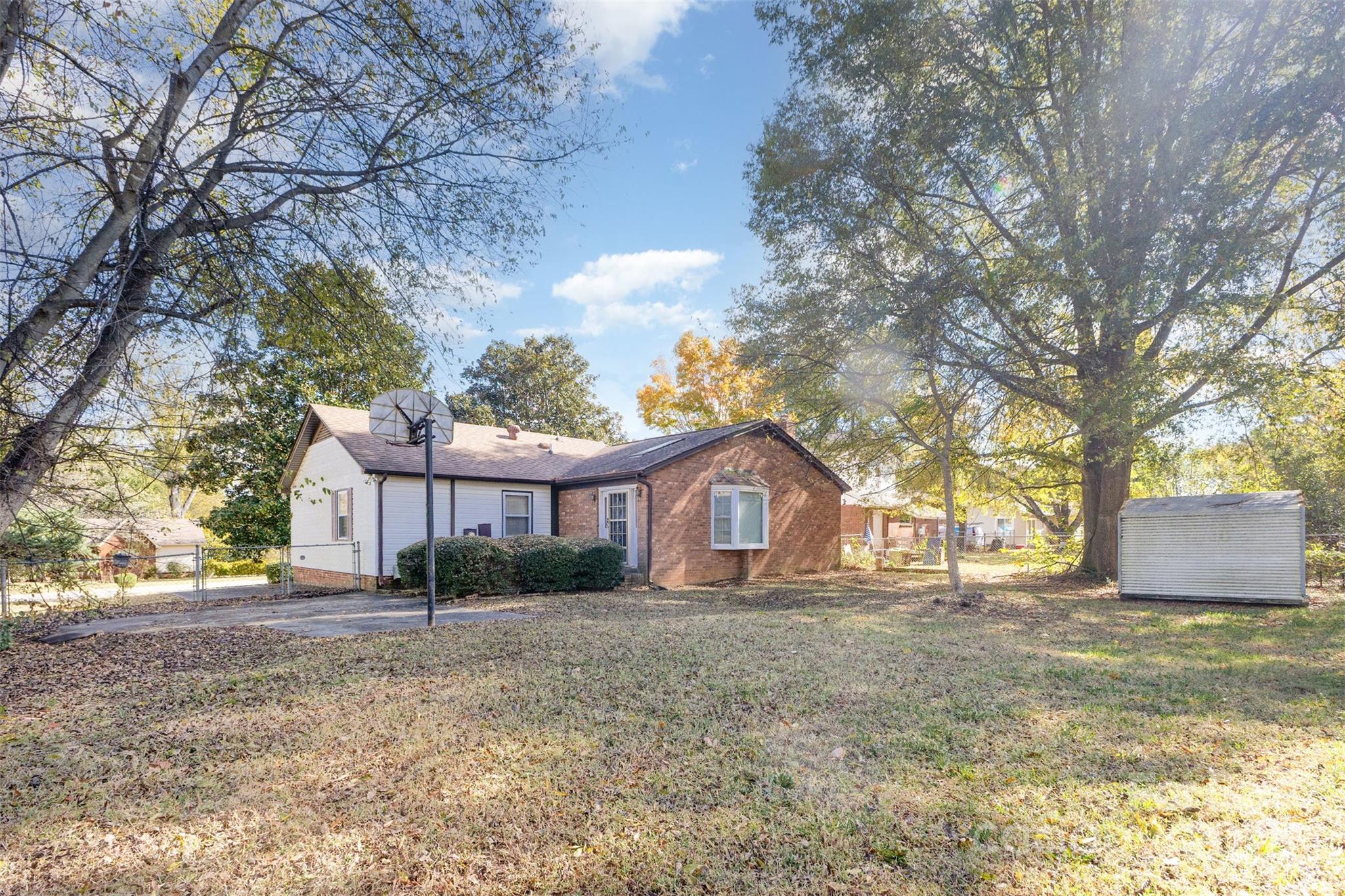 7428 Bradgate Road Charlotte, NC 28217 - Photo 24 of 27 a front view of a house with a garden and trees