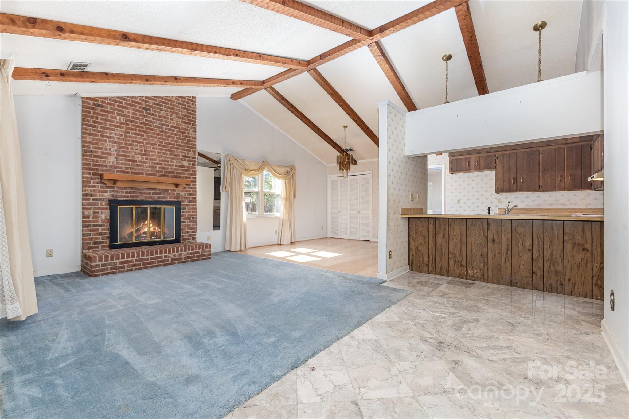 7428 Bradgate Road Charlotte, NC 28217 - Photo 3 of 27 a view of an empty room with a fireplace and a window