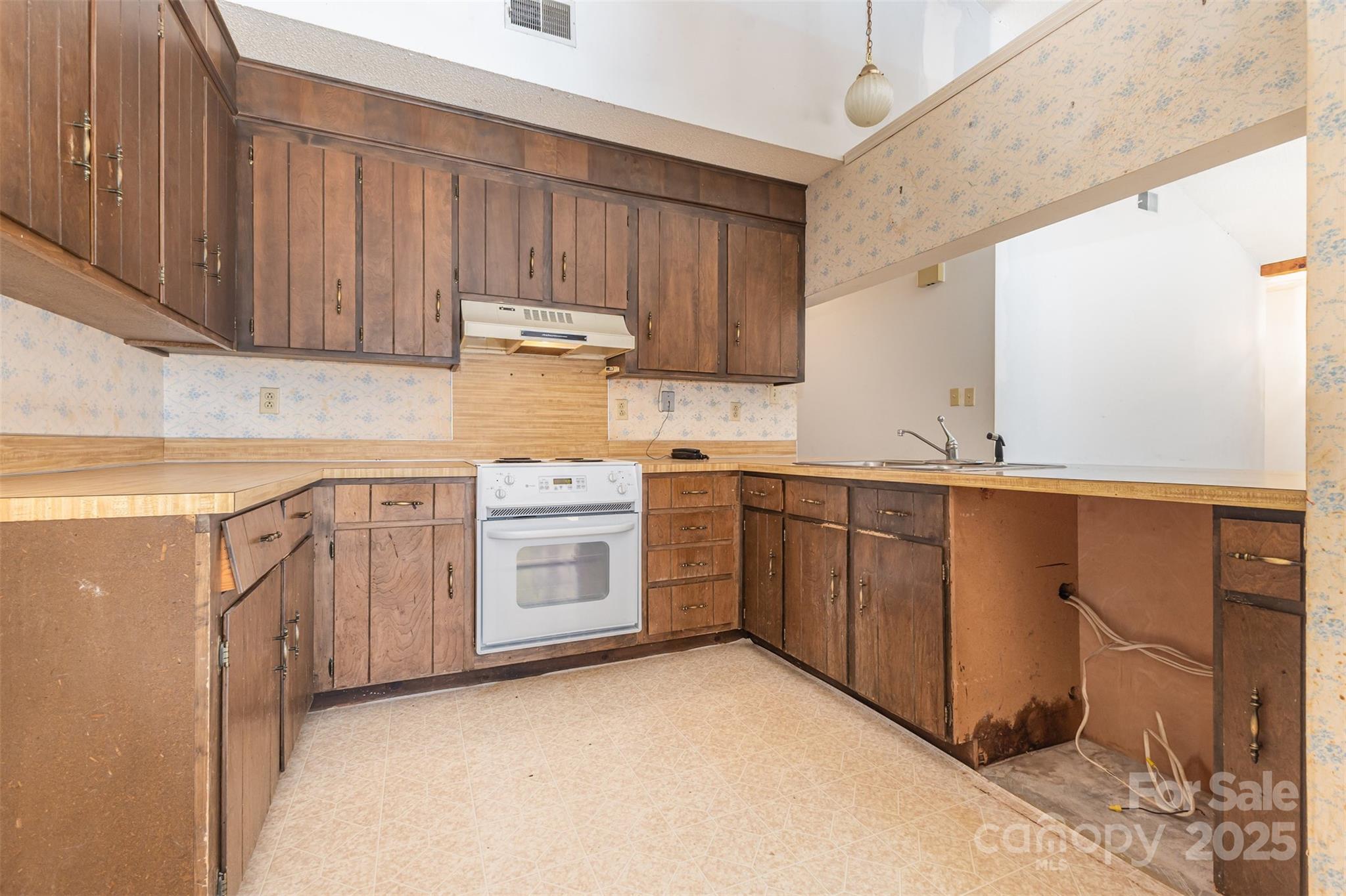 7428 Bradgate Road Charlotte, NC 28217 - Photo 5 of 27 a kitchen with sink a stove and cabinets