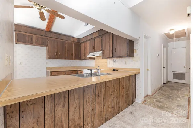 a kitchen with a sink a stove and cabinets