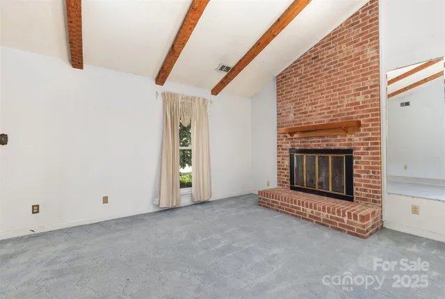 a view of empty room with fireplace