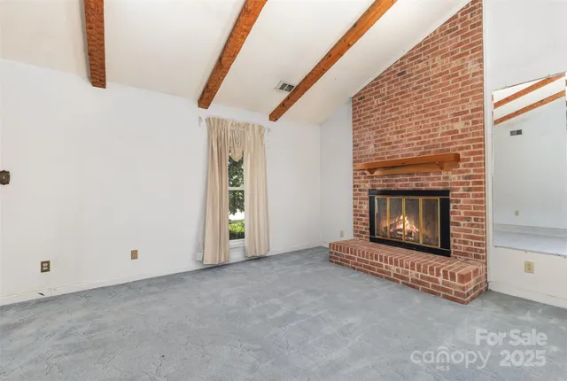 a view of empty room with fireplace