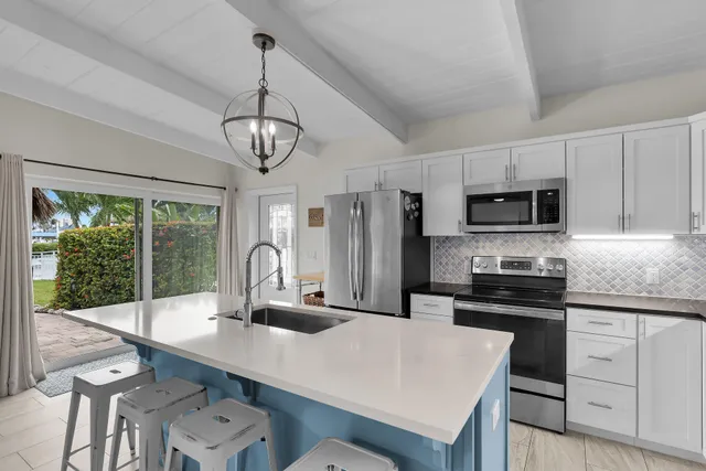 a kitchen with stainless steel appliances a refrigerator sink and cabinets