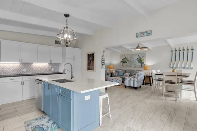 a kitchen with sink cabinets and wooden floor