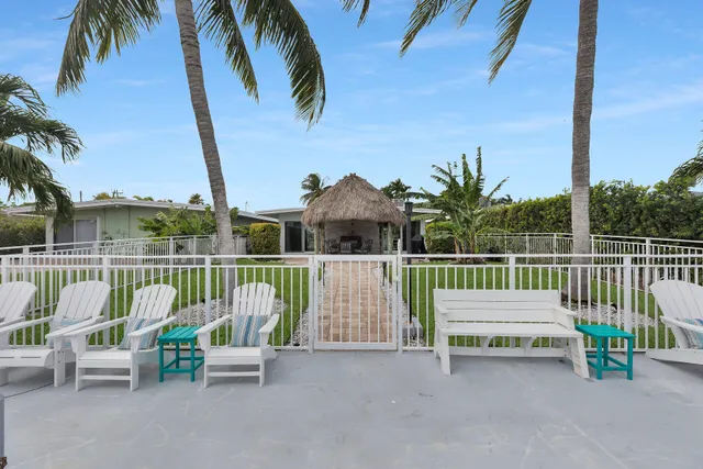 a view of a patio with a table chairs and garden