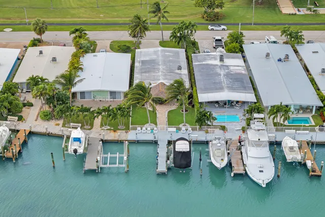 a front view of a house with a garden and trees
