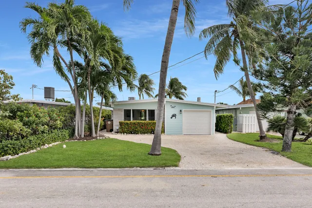 a kitchen that has a table chairs and stainless steel appliances