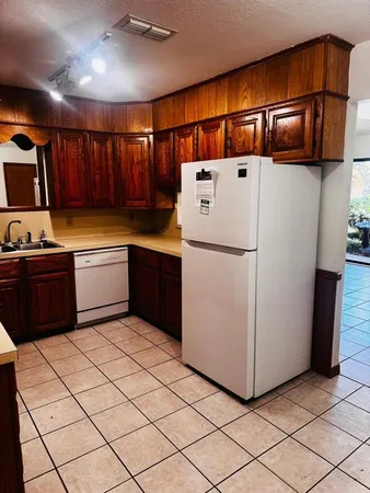 a kitchen with stainless steel appliances a refrigerator sink and cabinets