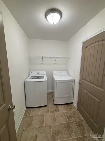 a view of an empty room with wooden floor and closet