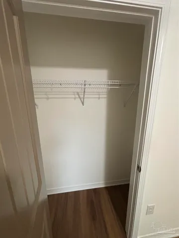 a bathroom with a granite countertop double vanity and a mirror
