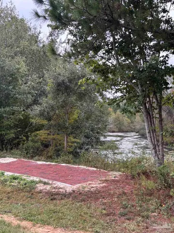 an empty room with wooden floor and natural light