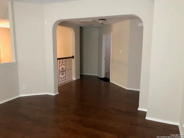 a view of hallway with wooden floor