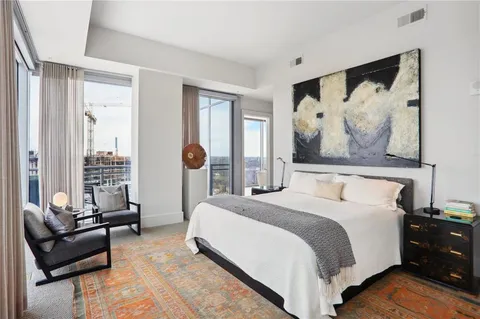 a bedroom with a bed couch and a window