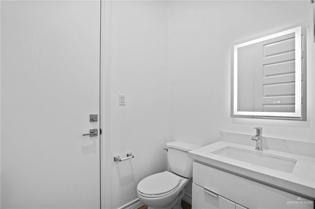 2716 East Conroe Road Edinburg, TX 78542 - Photo 23 of 31 Half bathroom featuring vanity and toilet