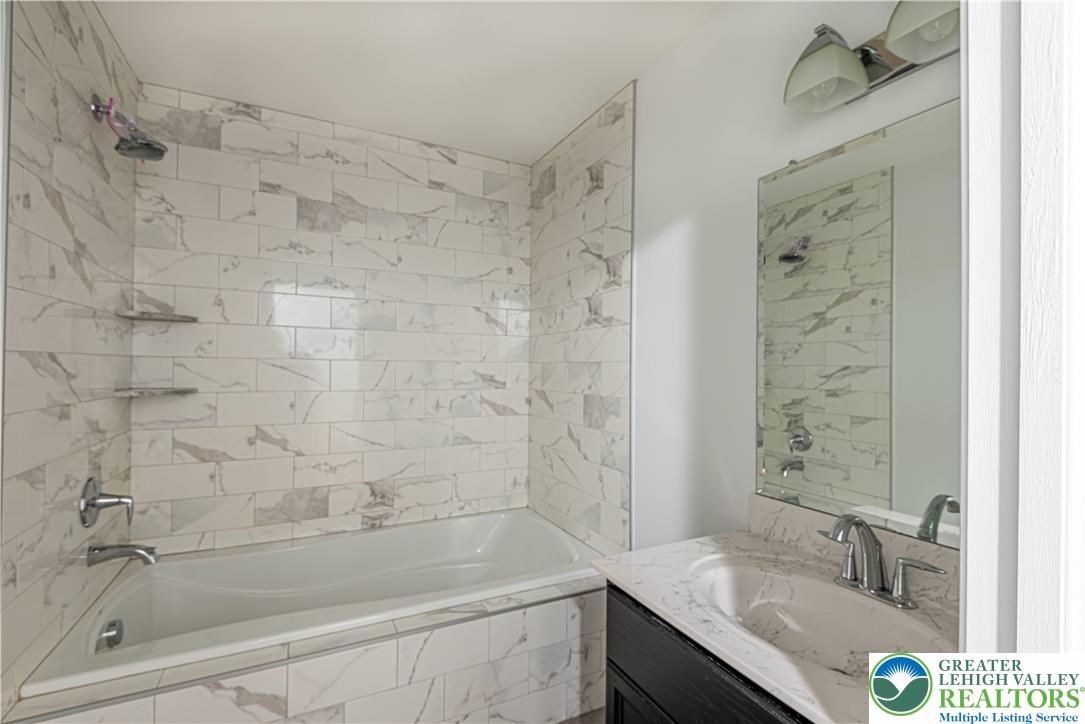 117 Cress Drive Effort, PA 18330 - Photo 14 of 29 a bathroom with a granite countertop sink a toilet and shower