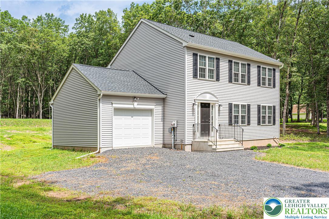 117 Cress Drive Effort, PA 18330 - Photo 29 of 29 a front view of a house with a yard and garage