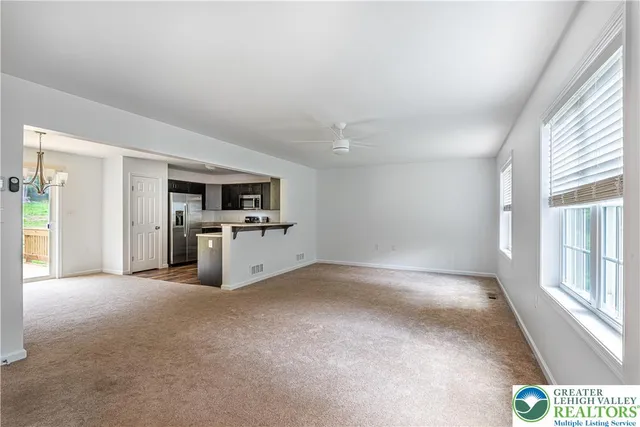 a view of a kitchen with a sink and dishwasher a refrigerator with wooden floor