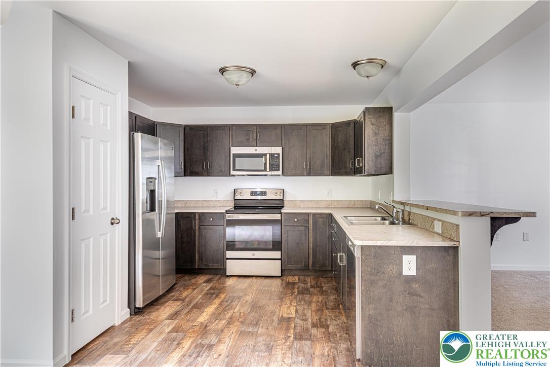 117 Cress Drive Effort, PA 18330 - Photo 7 of 29 a kitchen with stainless steel appliances granite countertop a refrigerator sink and stove