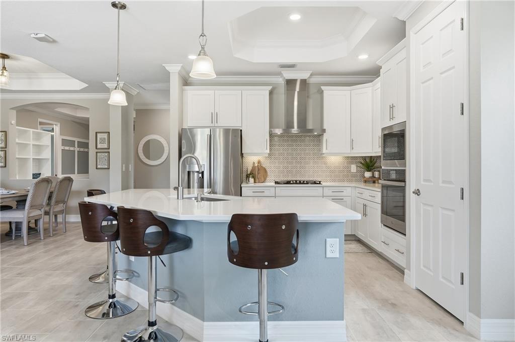 15194 Blue Bay Circle Fort Myers, FL 33913 - Photo 14 of 50 a kitchen with stainless steel appliances kitchen island a chandelier