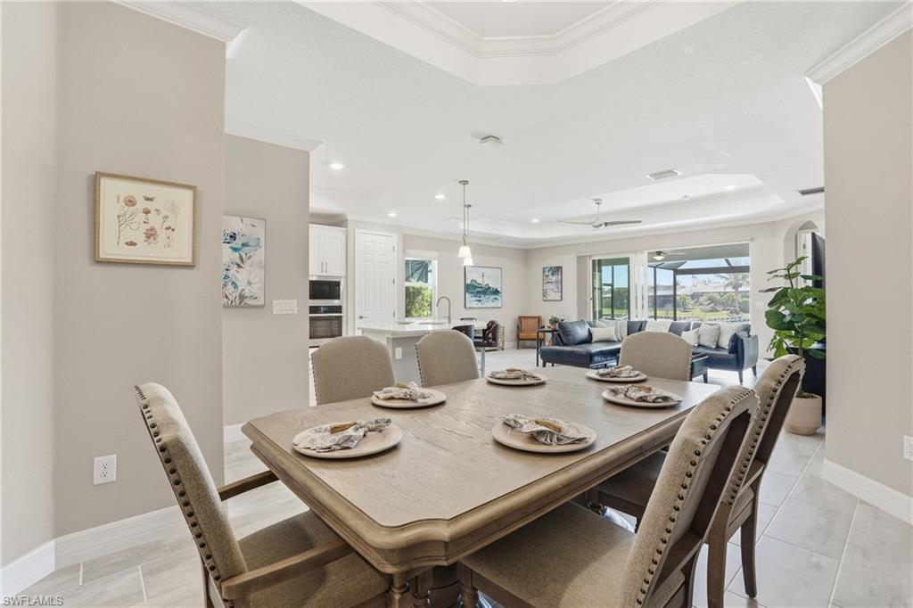 15194 Blue Bay Circle Fort Myers, FL 33913 - Photo 20 of 50 a view of a dining room and livingroom view with furniture wooden floor and a rug