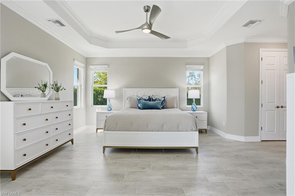 15194 Blue Bay Circle Fort Myers, FL 33913 - Photo 21 of 50 a bedroom with a large bed and a dresser