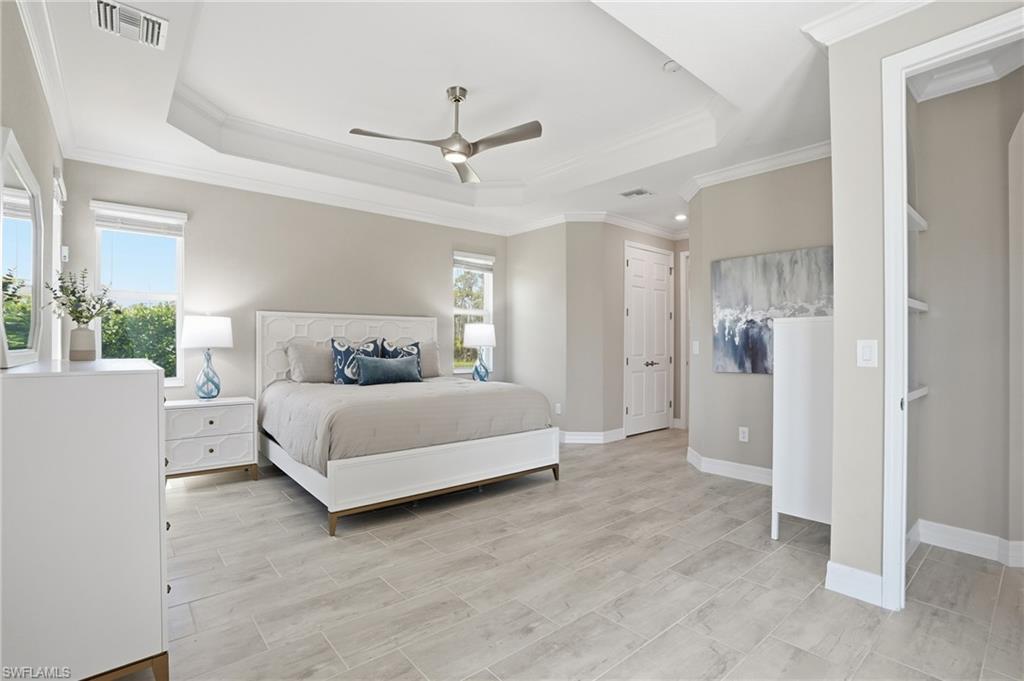 15194 Blue Bay Circle Fort Myers, FL 33913 - Photo 22 of 50 a bedroom with a bed and a ceiling fan