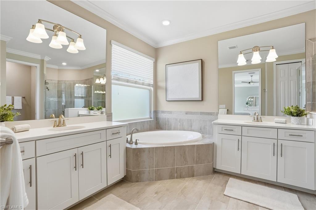 15194 Blue Bay Circle Fort Myers, FL 33913 - Photo 26 of 50 a bathroom with a sink double vanity granite and a mirror