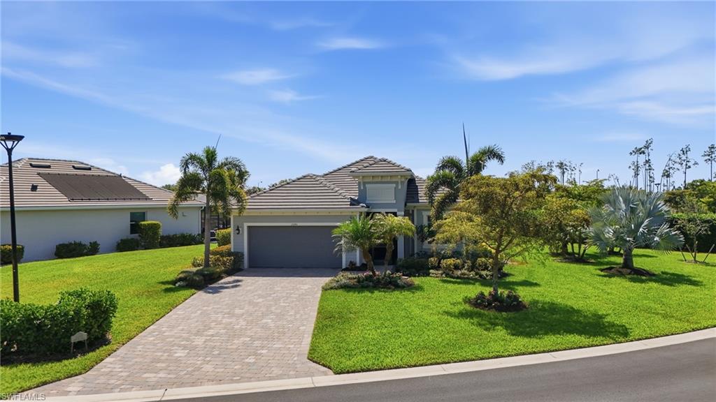 15194 Blue Bay Circle Fort Myers, FL 33913 - Photo 3 of 50 a front view of a house with a yard and potted plants