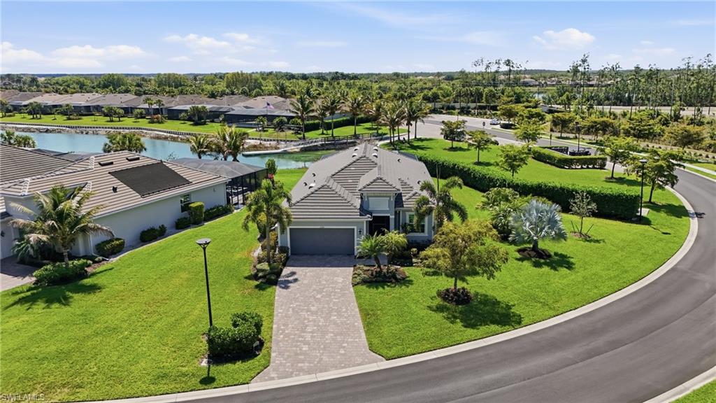 15194 Blue Bay Circle Fort Myers, FL 33913 - Photo 4 of 50 an aerial view of a house with a garden and lake view