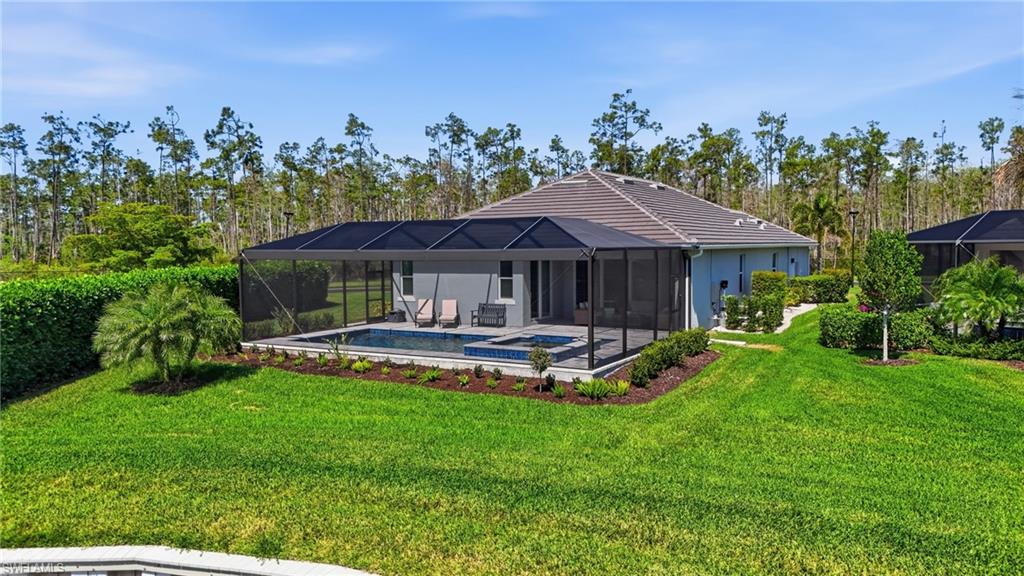 15194 Blue Bay Circle Fort Myers, FL 33913 - Photo 41 of 50 a front view of a house with a garden and swimming pool