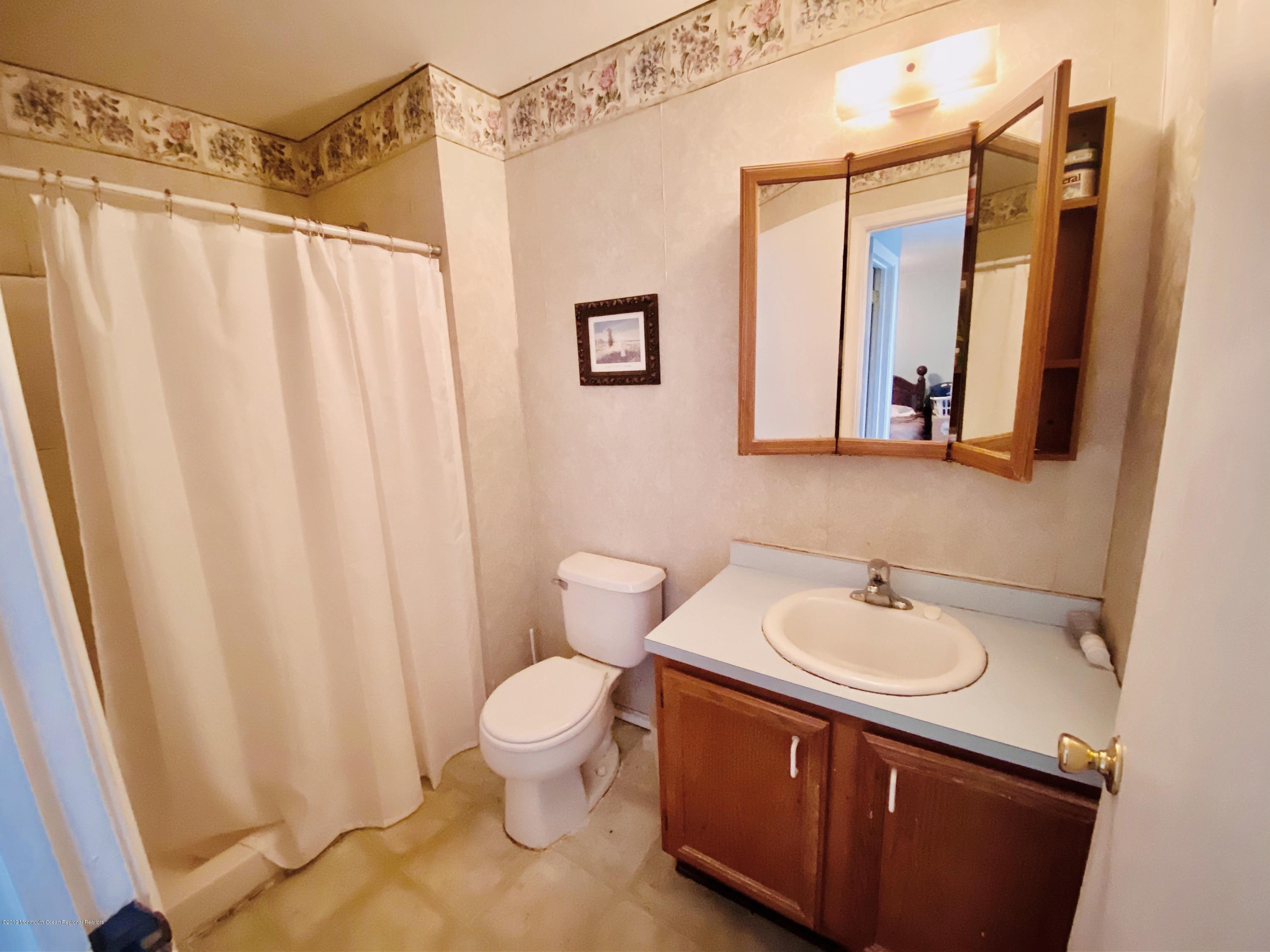 47 Dockage Road Bayville, NJ 08721 - Photo 11 of 19 a bathroom with a sink a toilet and a mirror
