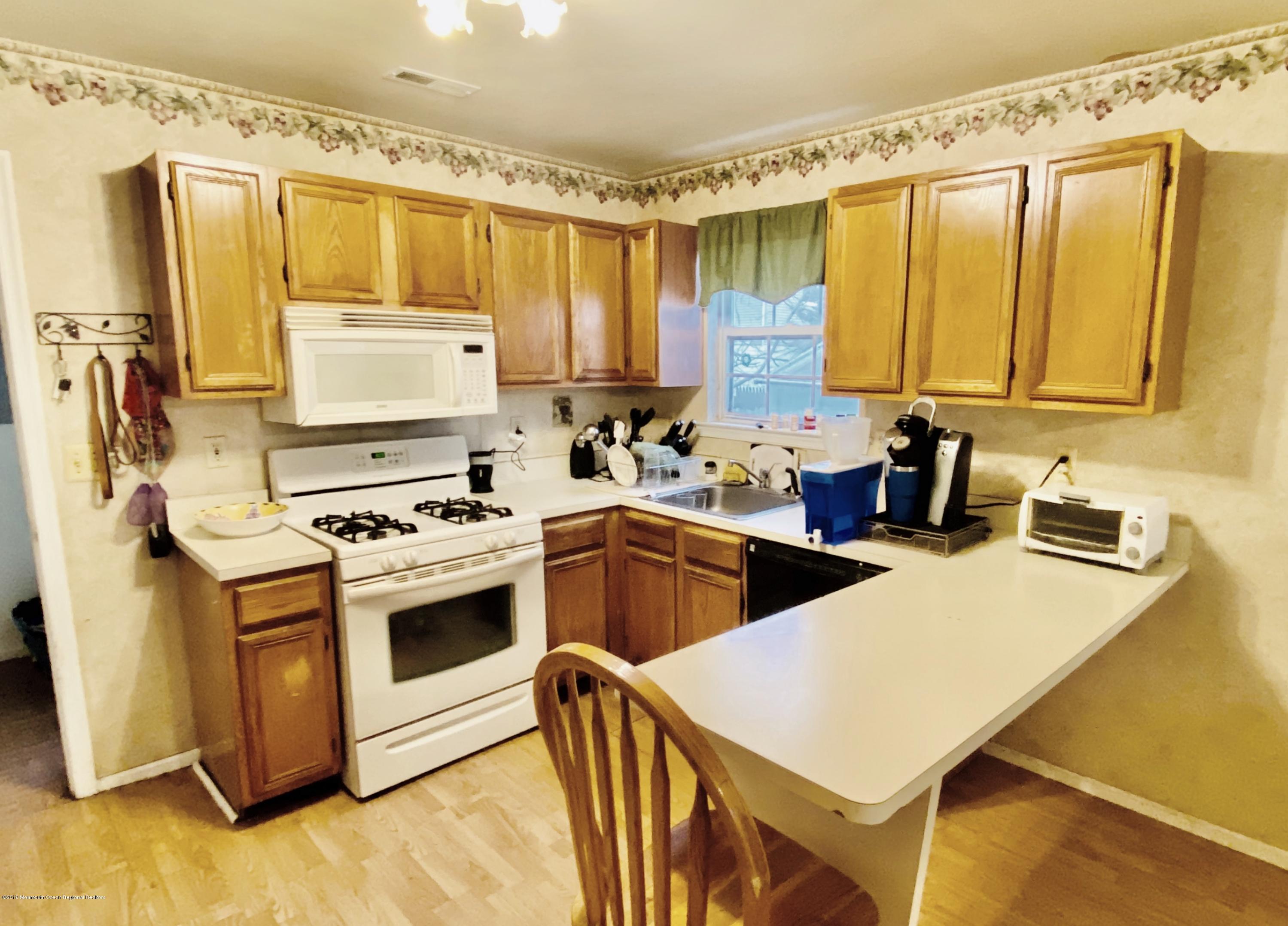 47 Dockage Road Bayville, NJ 08721 - Photo 6 of 19 a kitchen with stainless steel appliances a stove a sink and a refrigerator
