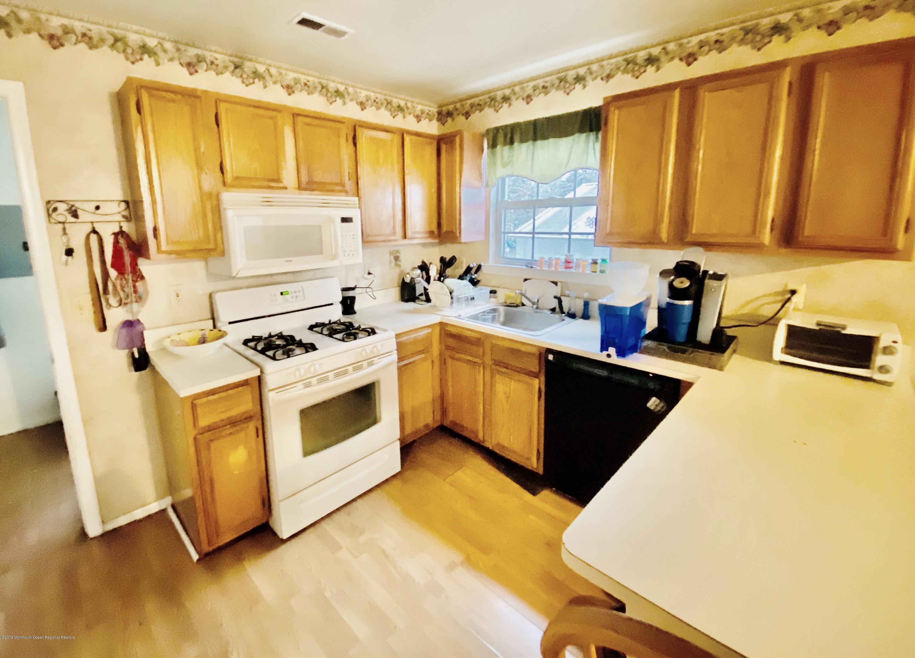 47 Dockage Road Bayville, NJ 08721 - Photo 7 of 19 a kitchen with a stove a sink and a refrigerator