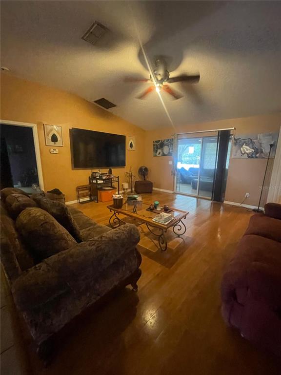 396 Kettering Road Deltona, FL 32725 - Photo 6 of 25 a living room with furniture and a flat screen tv