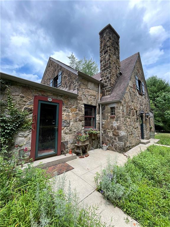 715 Old Mill Road Pittsburgh, PA 15238 - Photo 2 of 46 Fieldstone exterior, pitched gable roof & prominent chimney stack are features of a cottage-style home.