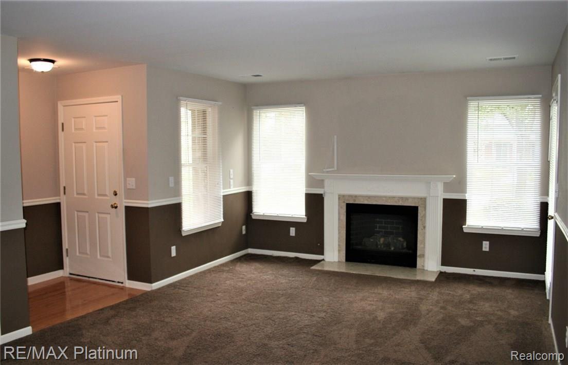 4074 Hampton Ridge Boulevard, Unit 58 Howell, MI 48843 - Photo 5 of 37 Wainscoting dresses up the living room, newer carpet too~