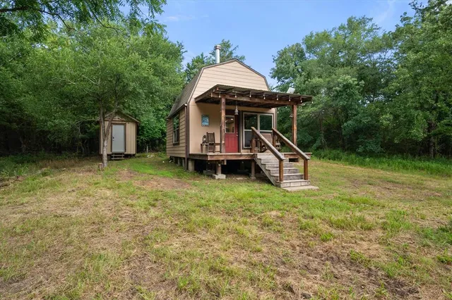 a backyard of a house with table and chairs