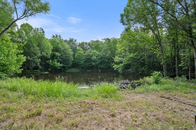 a bathroom with a granite countertop shower a mirror and a sink