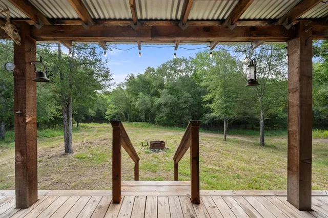 a kitchen with stainless steel appliances granite countertop a table chairs and a refrigerator