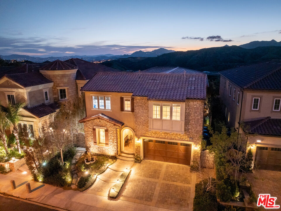 12015 North Ricasoli Way Porter Ranch, CA 91326 - Photo 1 of 68 a front view of a house with a yard