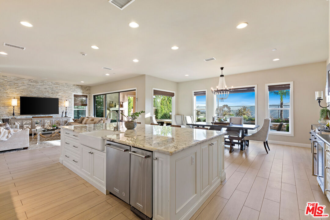 12015 North Ricasoli Way Porter Ranch, CA 91326 - Photo 16 of 68 a kitchen with lots of counter top space and living room