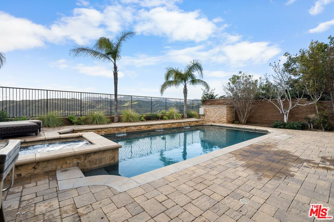 12015 North Ricasoli Way Porter Ranch, CA 91326 - Photo 25 of 68 a view of swimming pool with seating area and trees in the background