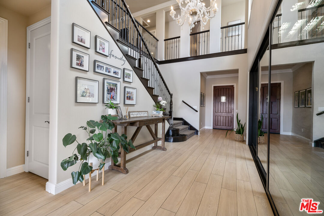 12015 North Ricasoli Way Porter Ranch, CA 91326 - Photo 26 of 68 a view of a hallway with wooden floor and stairs