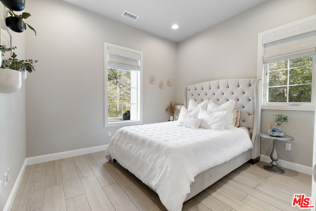 12015 North Ricasoli Way Porter Ranch, CA 91326 - Photo 28 of 68 a large bed sitting in a bedroom next to a window