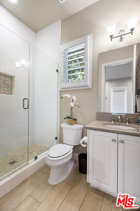 12015 North Ricasoli Way Porter Ranch, CA 91326 - Photo 31 of 68 a spacious bathroom with a granite countertop toilet a sink and a mirror